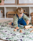 Toddler playing with wooden toys on Panda Dreams Cotton Luxury Round Playmat - Rolling Panda